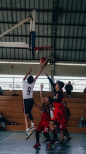 A group of young men playing a game of basketball