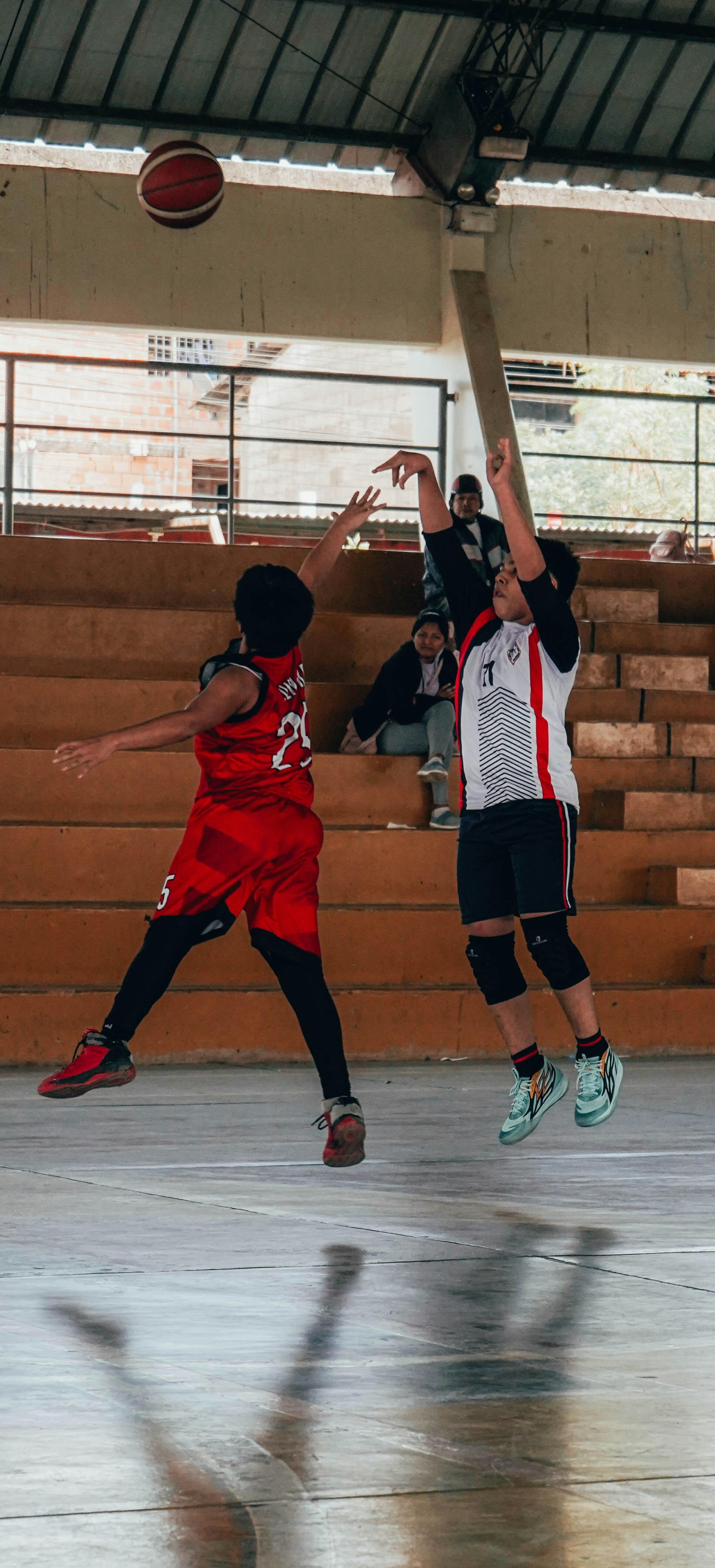 A group of young men playing a game of basketball