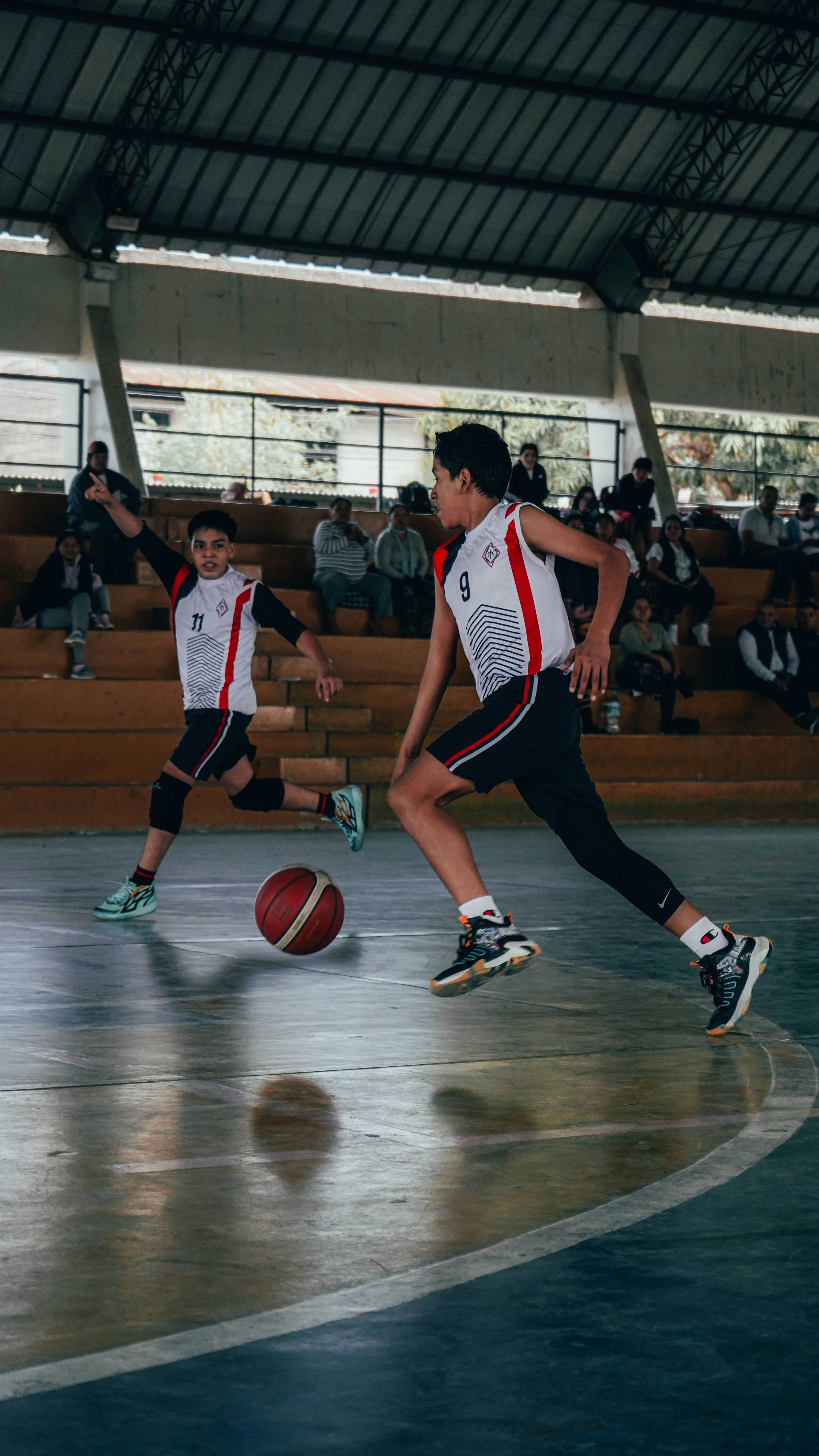A group of young men playing a game of basketball