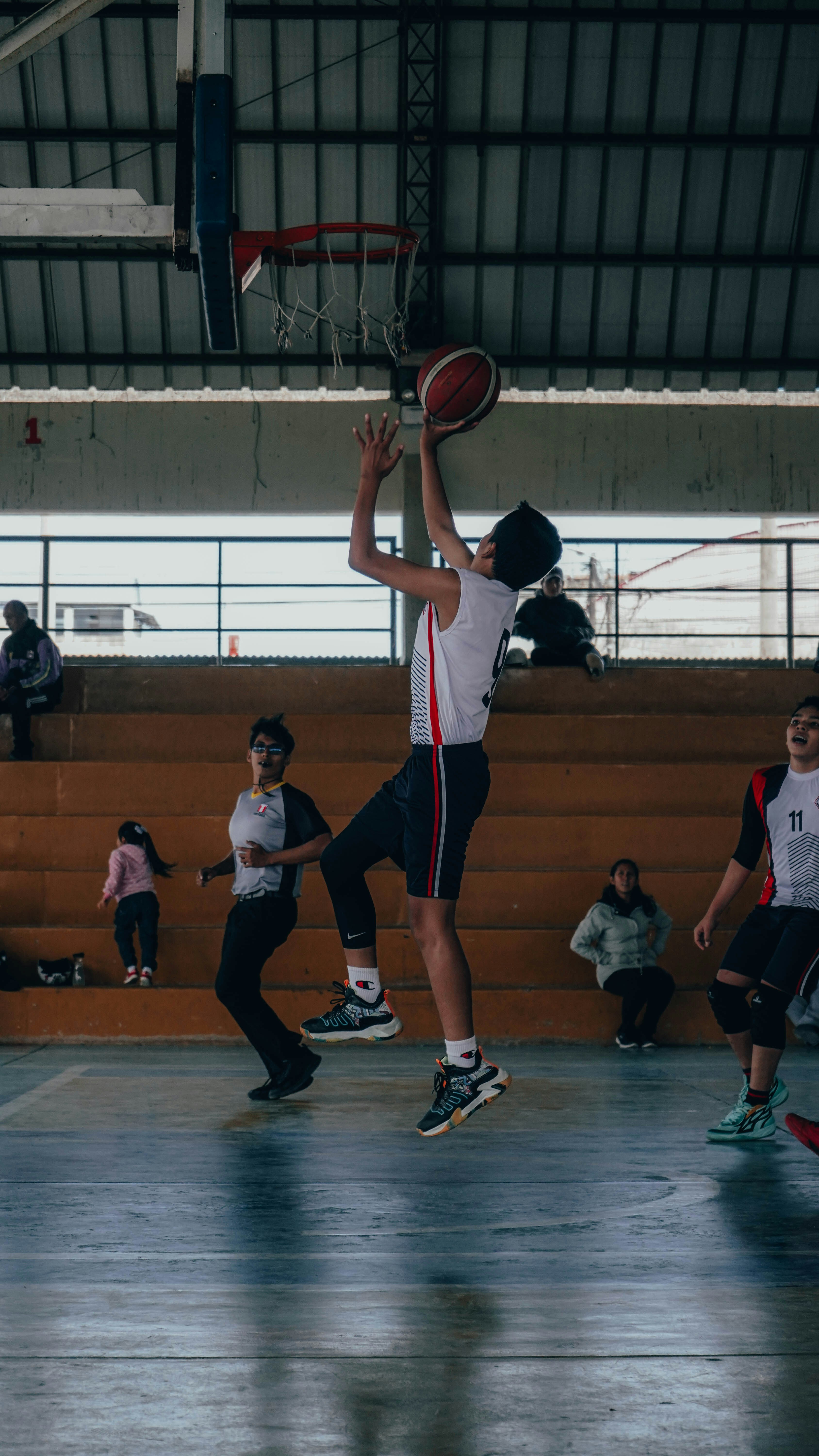 A group of young men playing a game of basketball