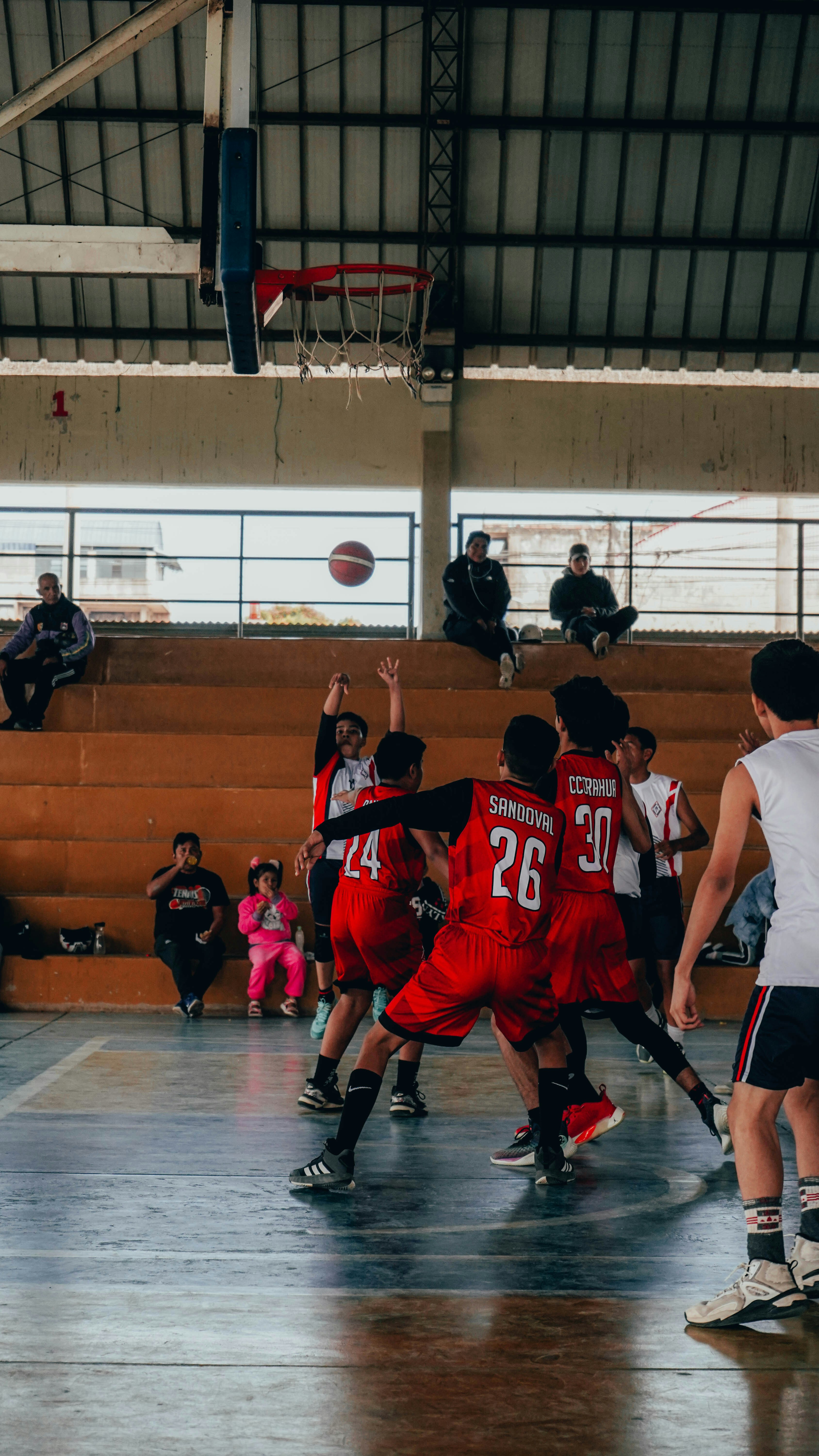 A group of young men playing a game of basketball
