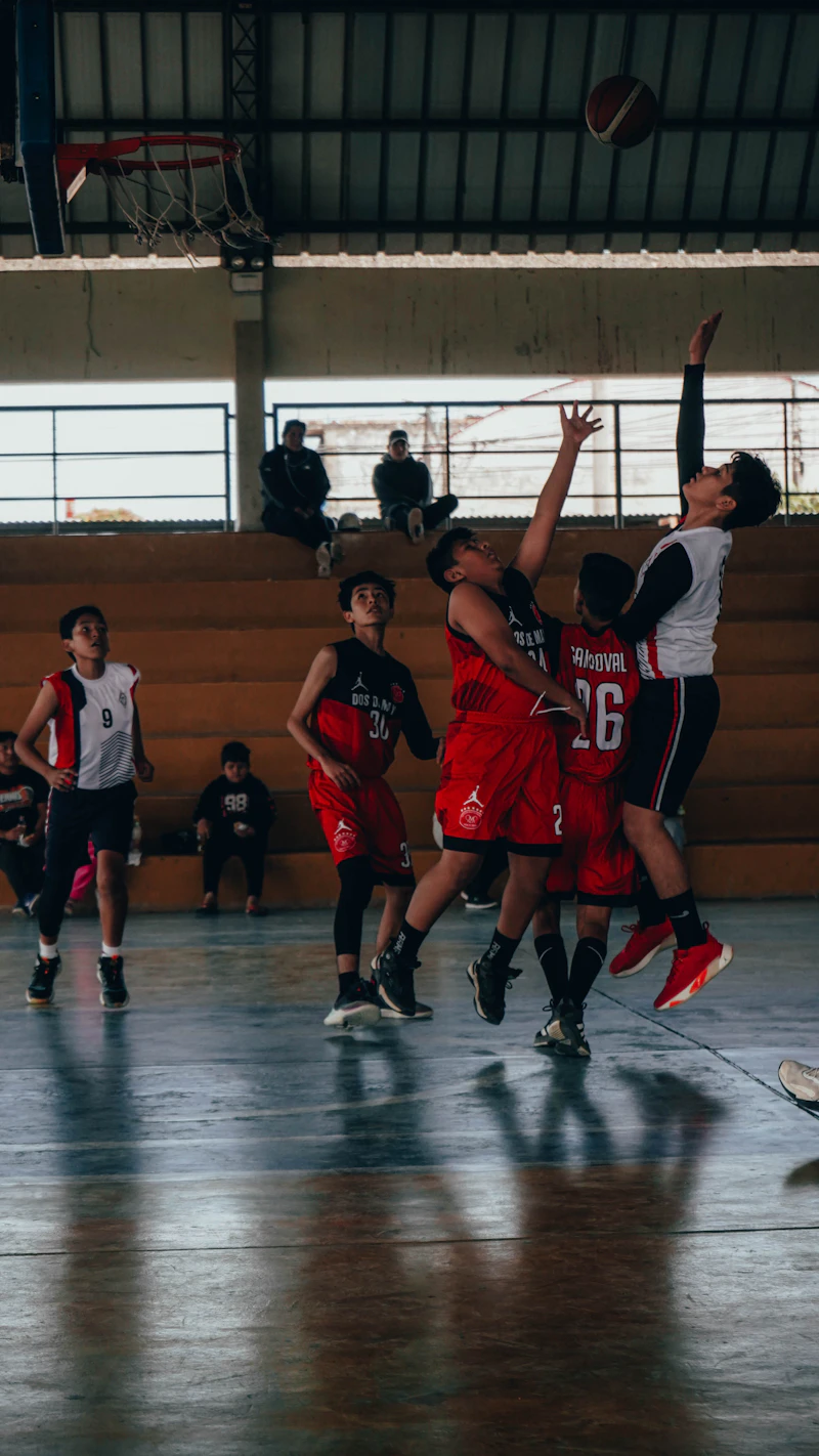 A group of young men playing a game of basketball