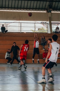 A group of young men playing a game of basketball