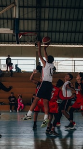 A group of young men playing a game of basketball