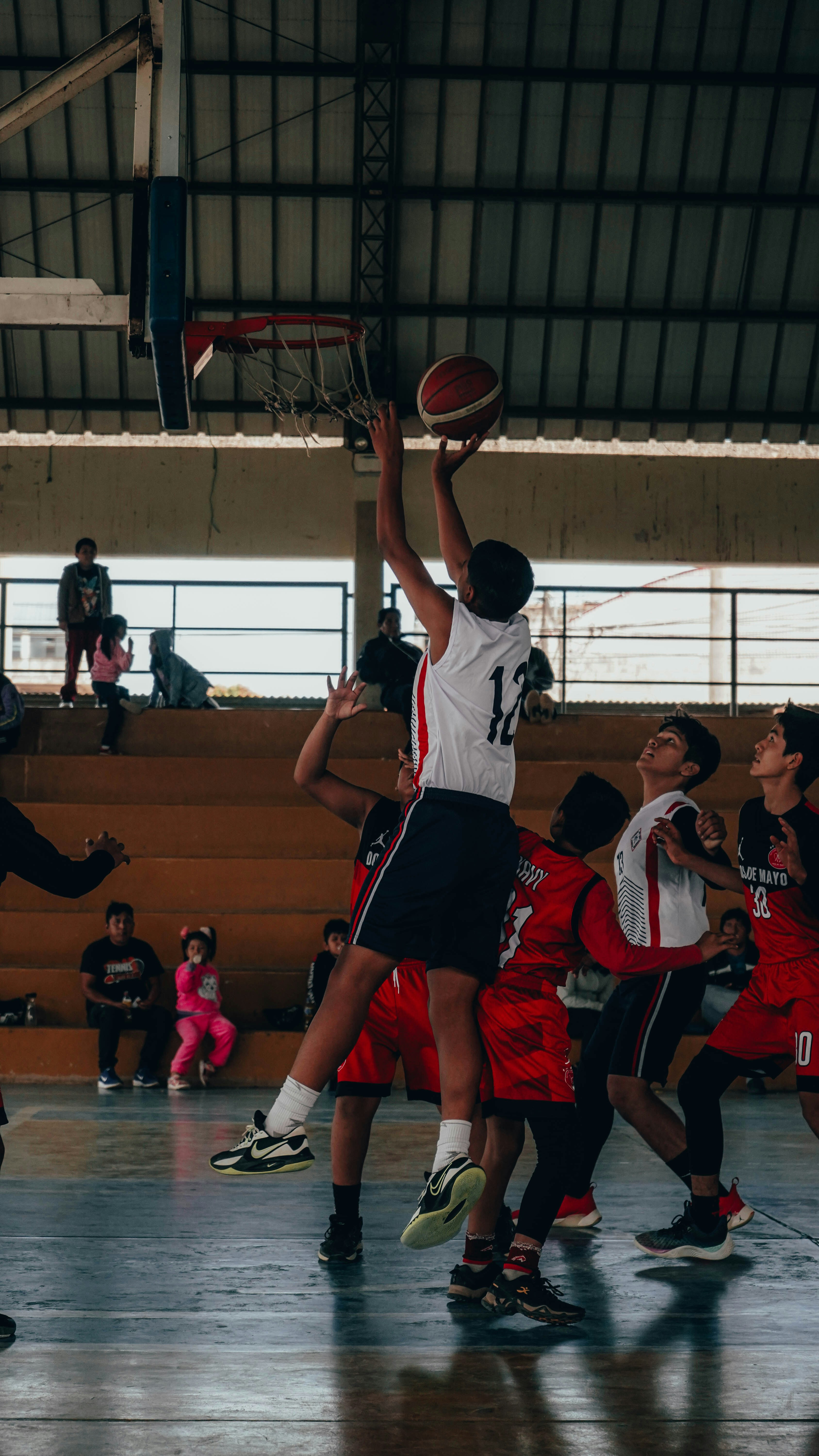 A group of young men playing a game of basketball