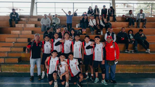 A group of young men standing next to each other on a basketball court