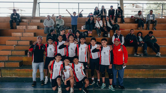 A group of young men standing next to each other on a basketball court