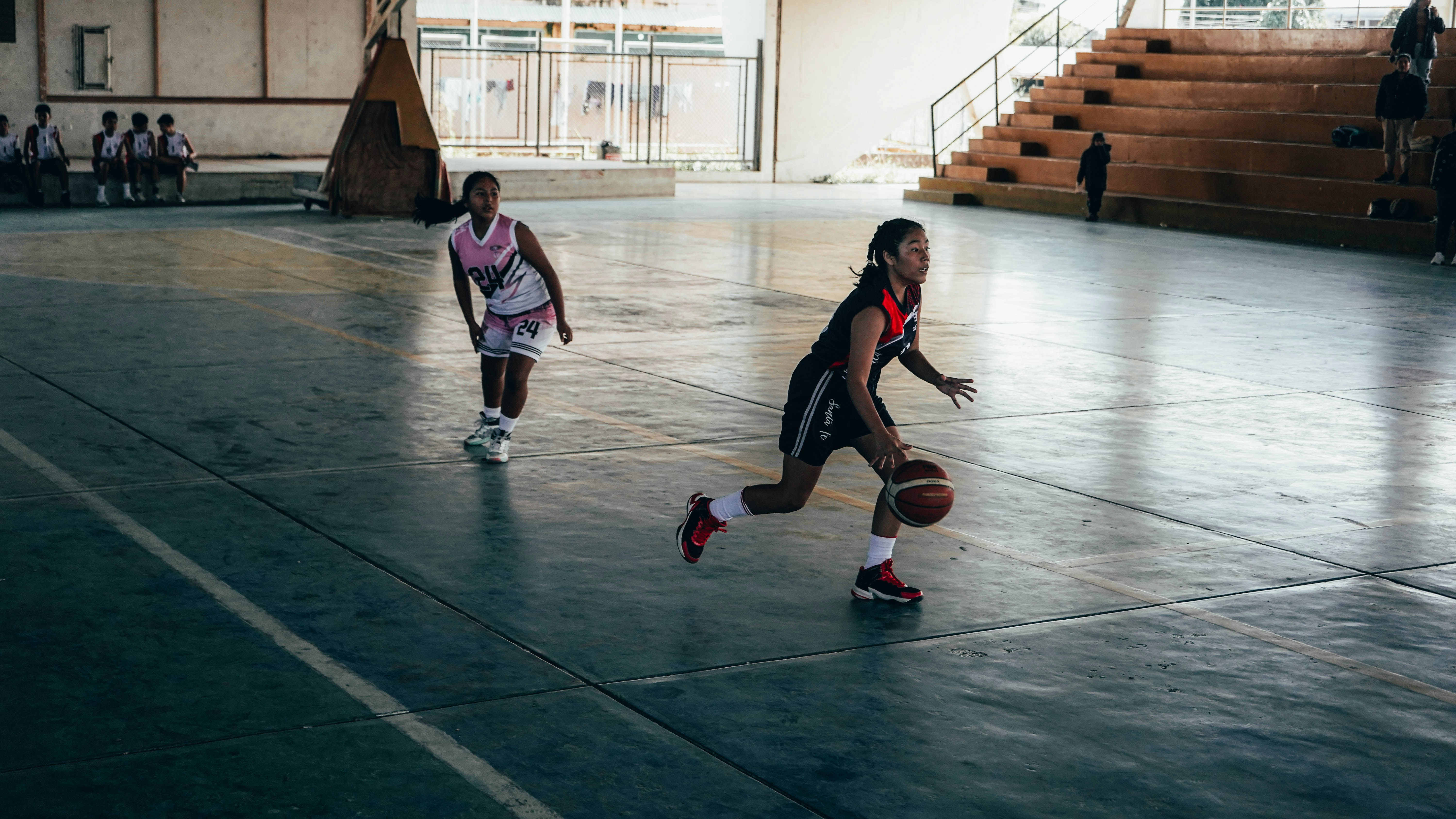 A group of young men playing a game of basketball