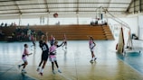 A group of young women playing a game of basketball