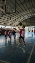 A group of young men playing a game of basketball