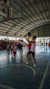 A group of young men playing a game of basketball