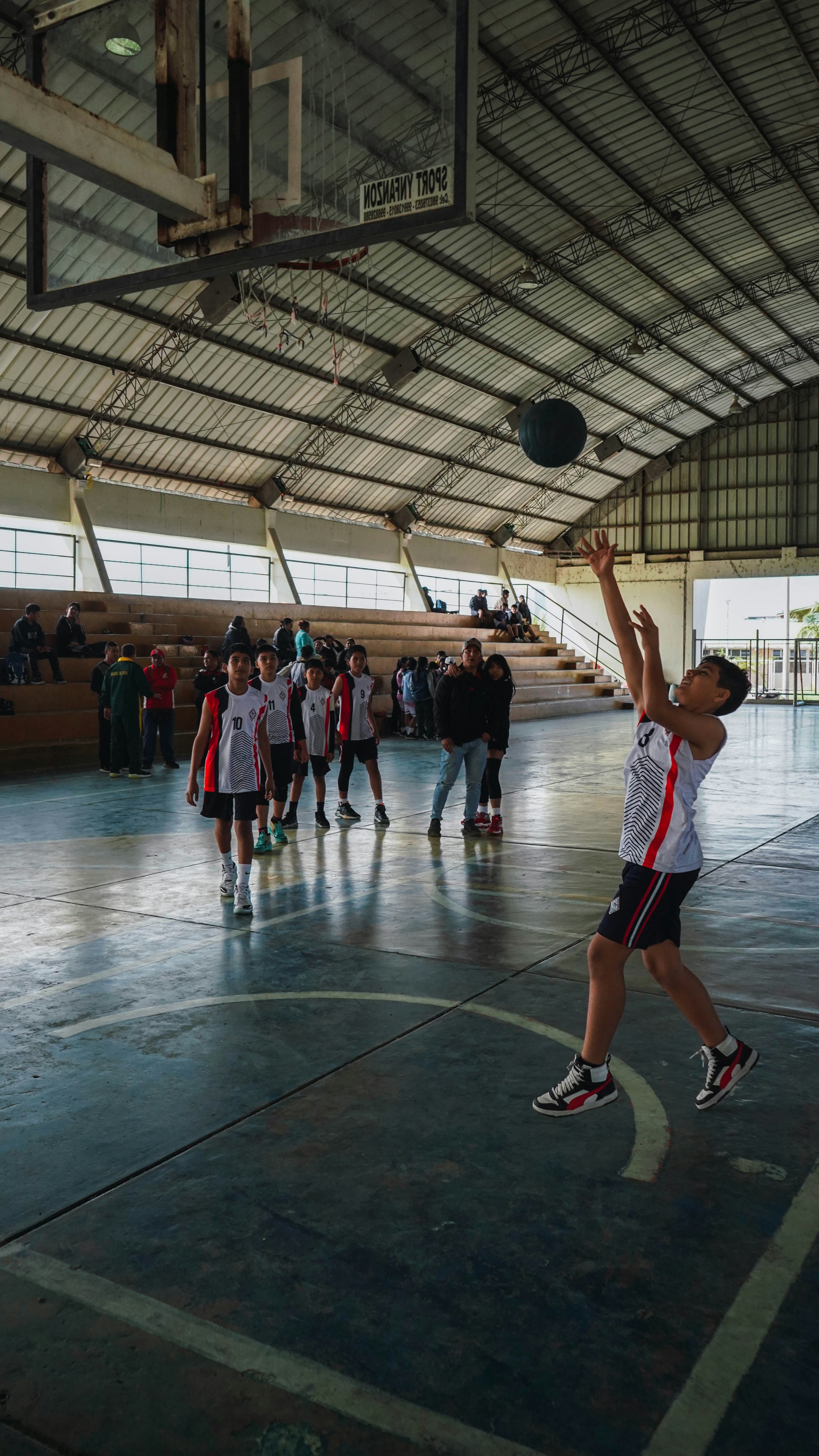 A group of young men playing a game of basketball