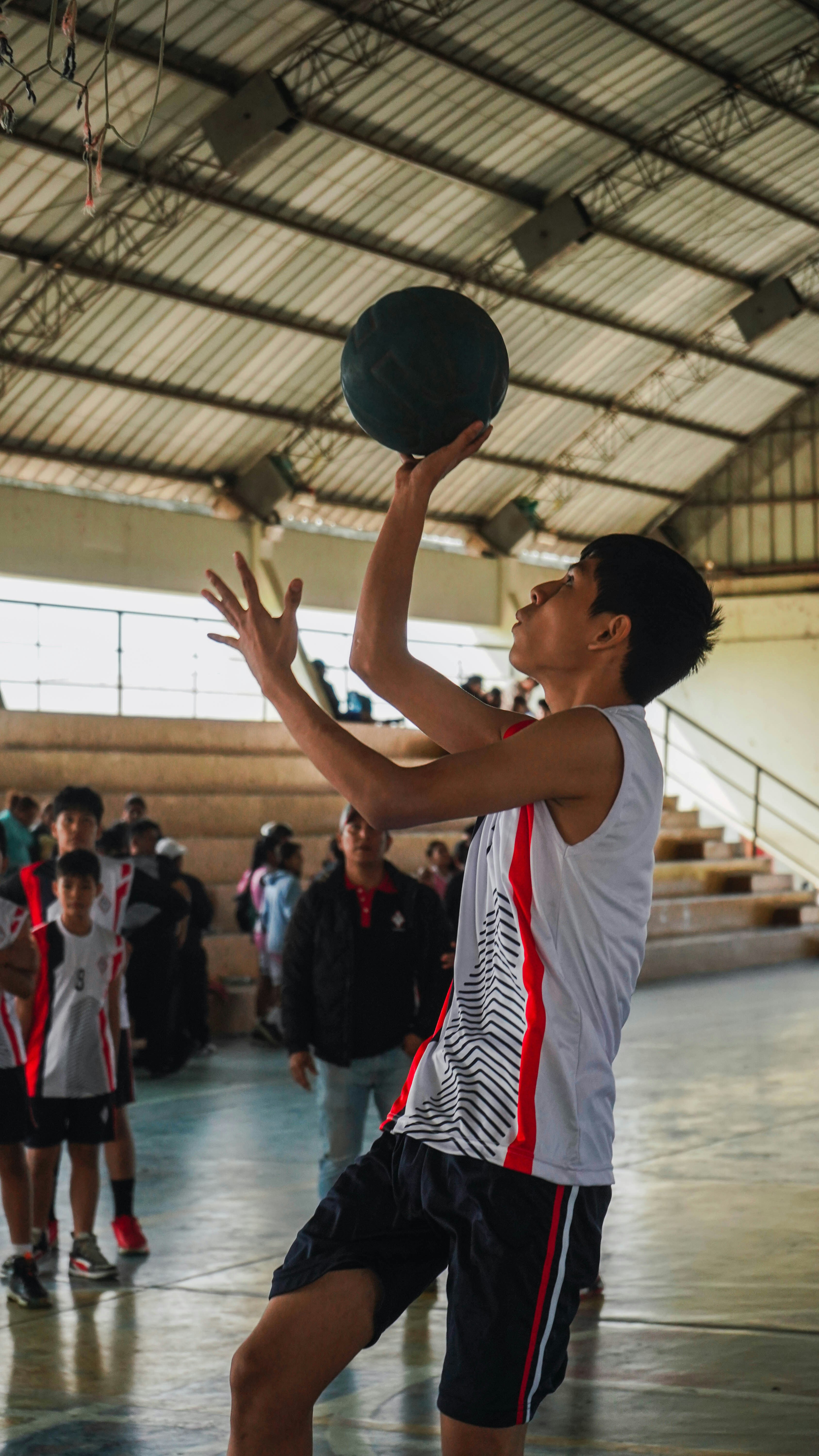 A group of young men playing a game of basketball