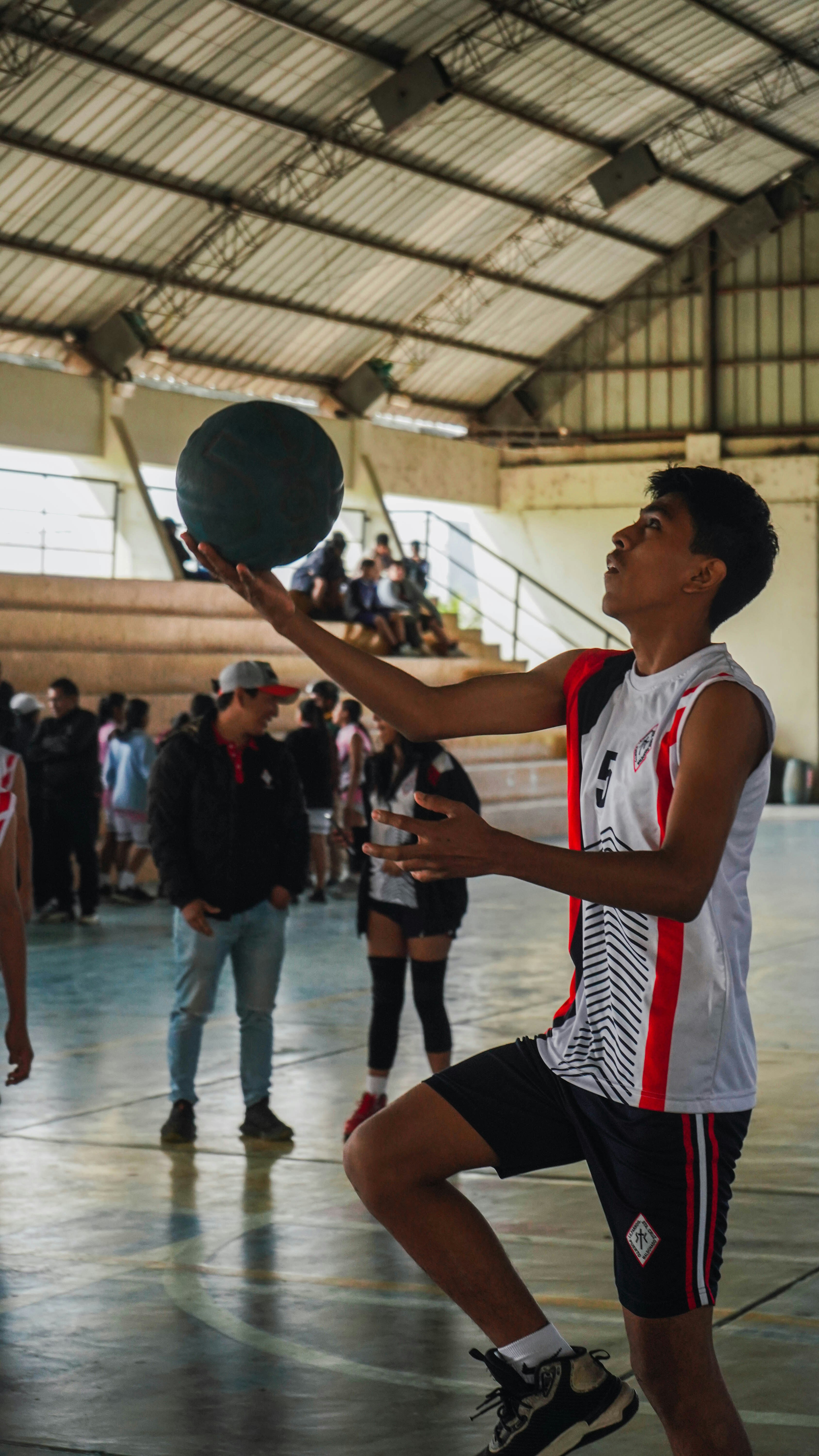 A group of young men playing a game of basketball