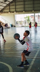 A group of young people playing a game of basketball