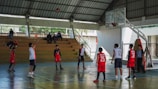 A group of young men standing on top of a basketball court