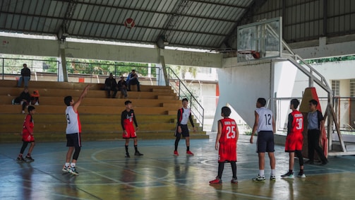 A group of young men standing on top of a basketball court