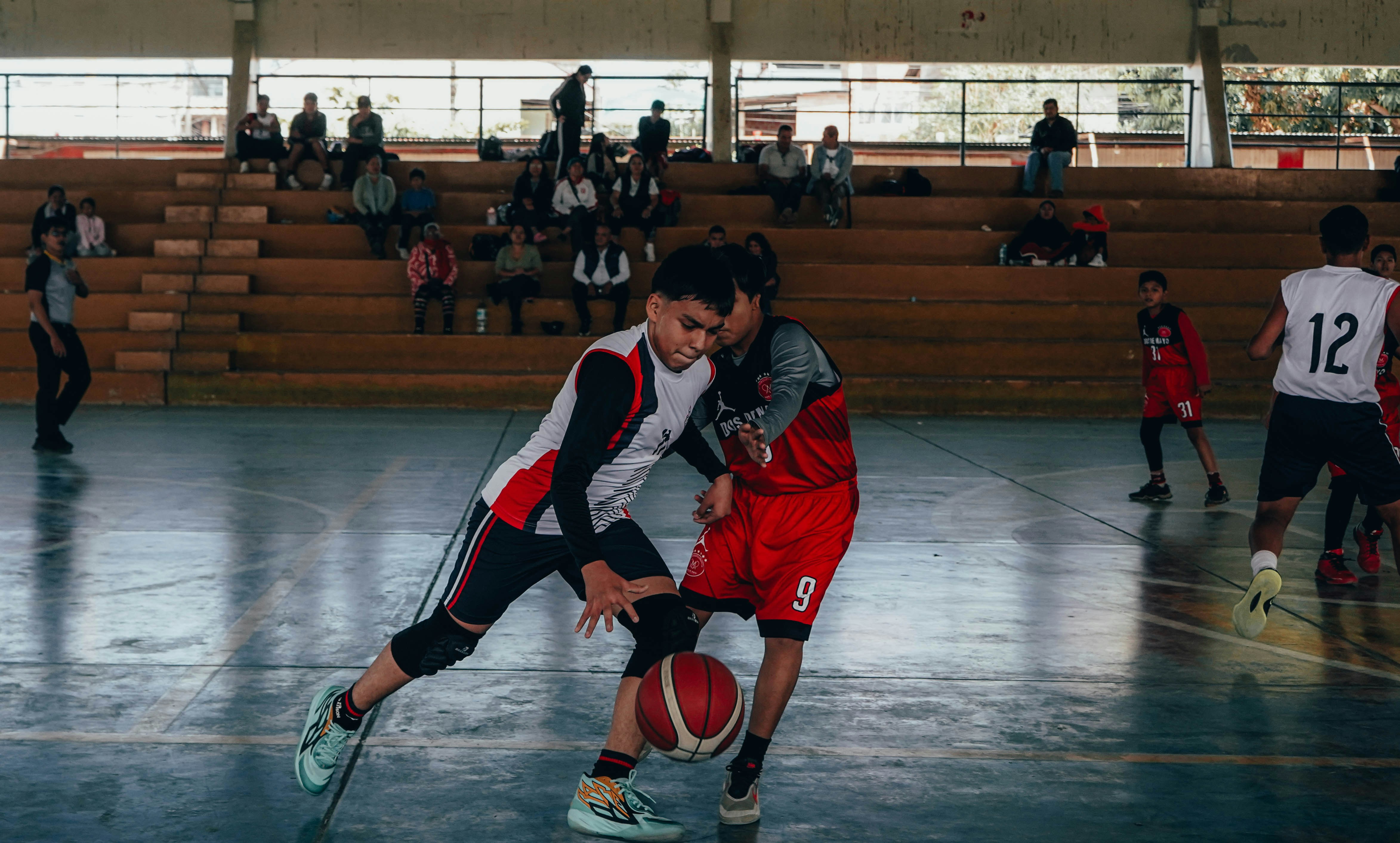 A group of young men playing a game of basketball