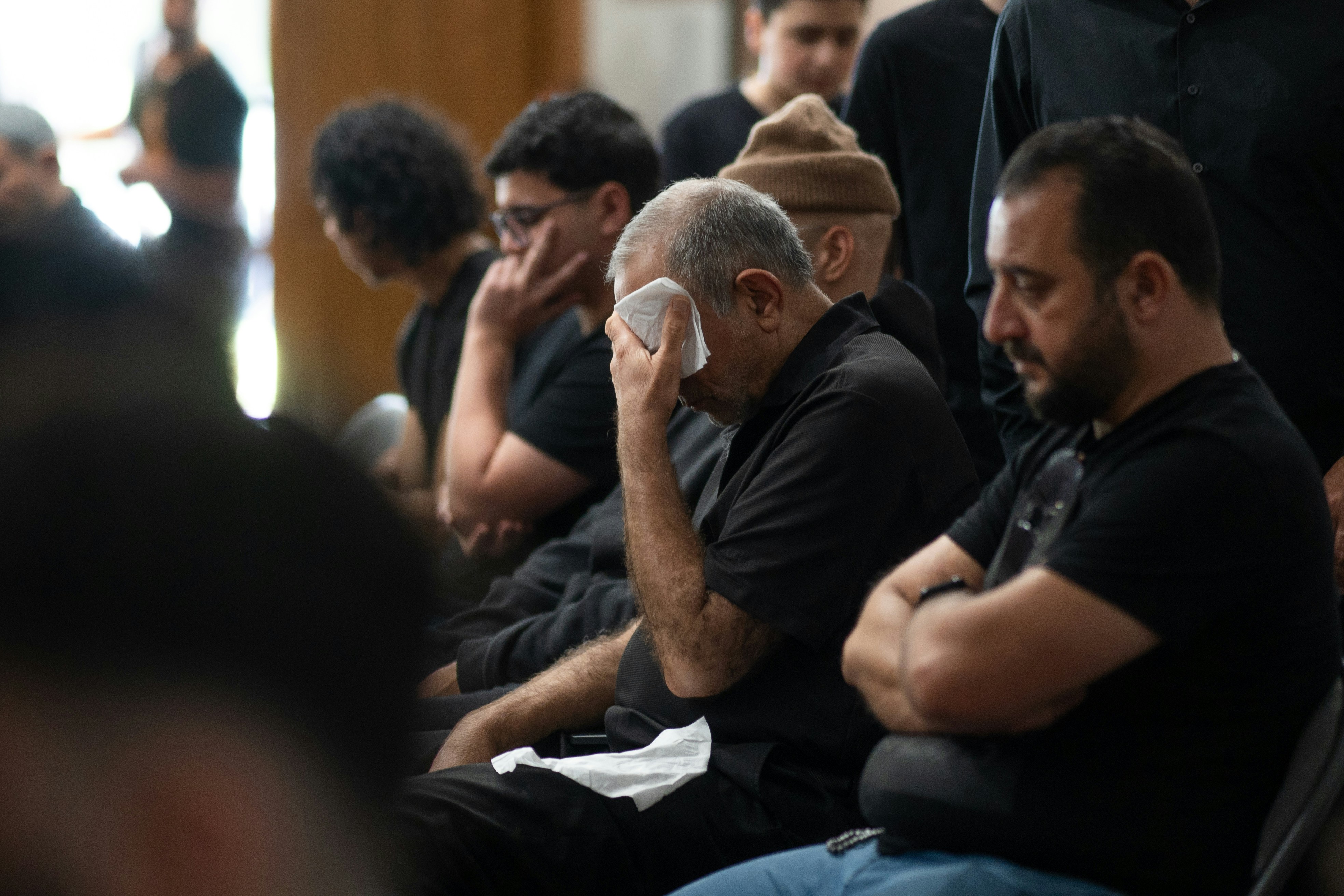 A group of men sitting next to each other