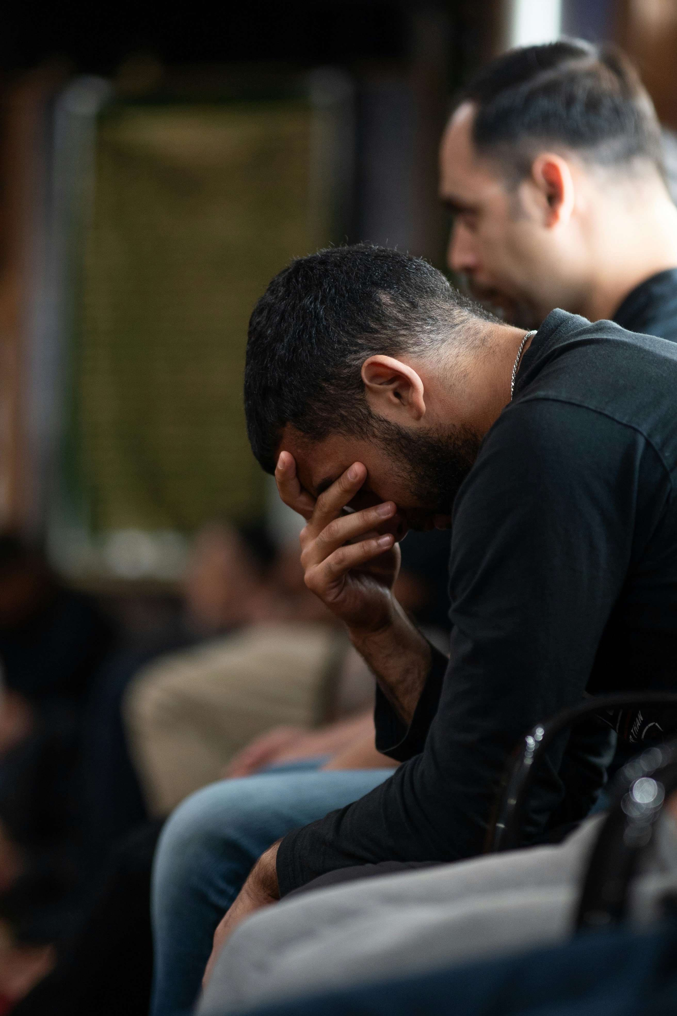 A couple of men sitting next to each other