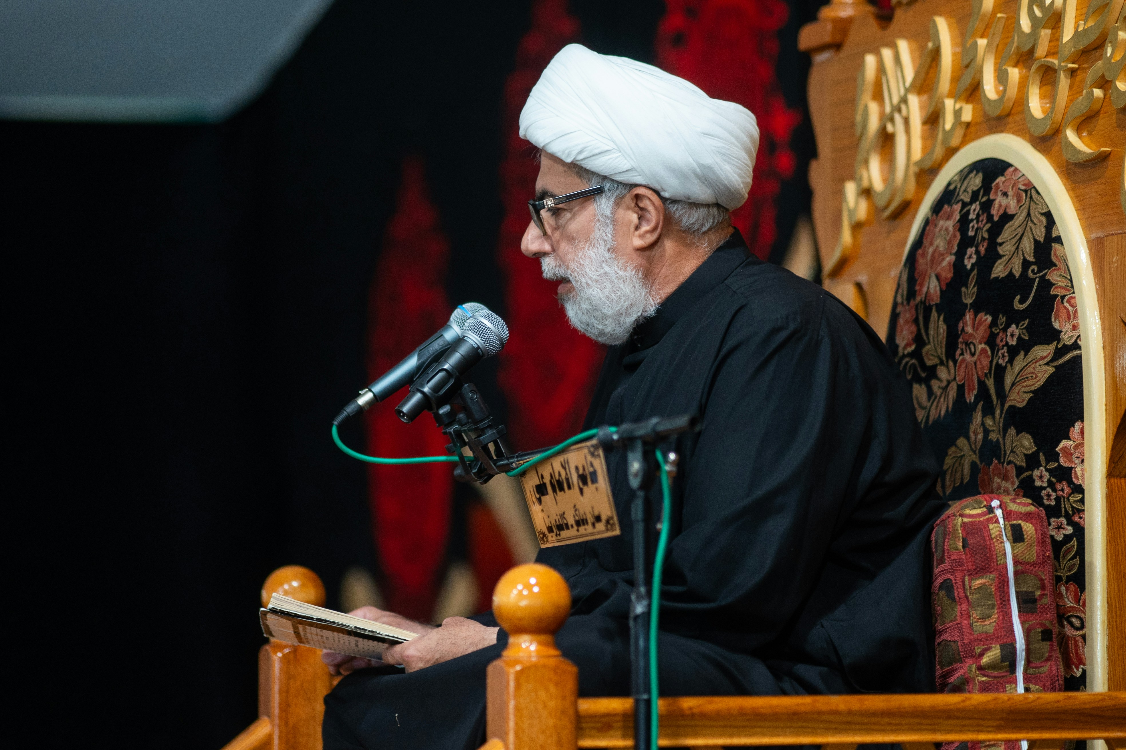 A man sitting at a table with a microphone