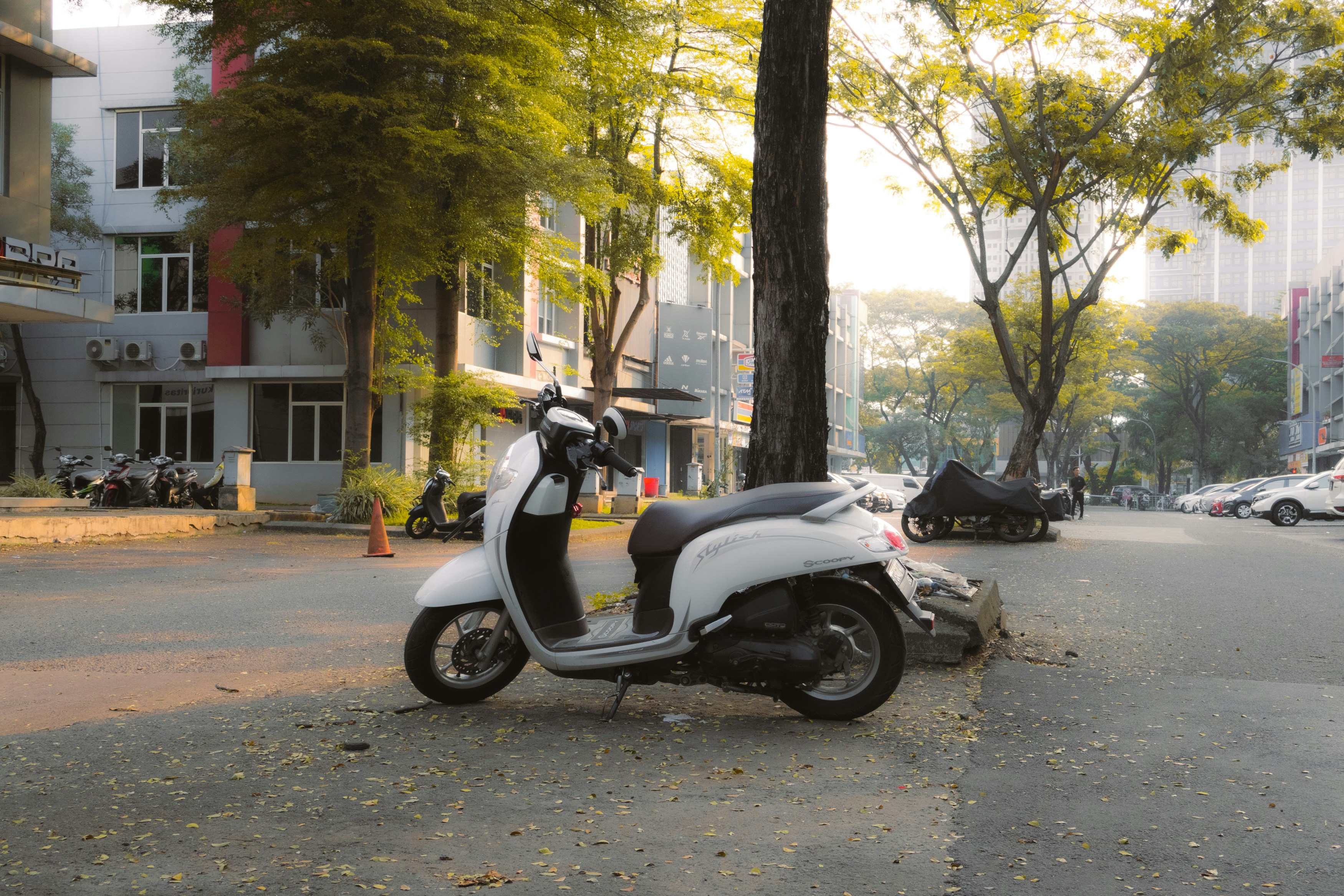 A scooter parked on the side of the road