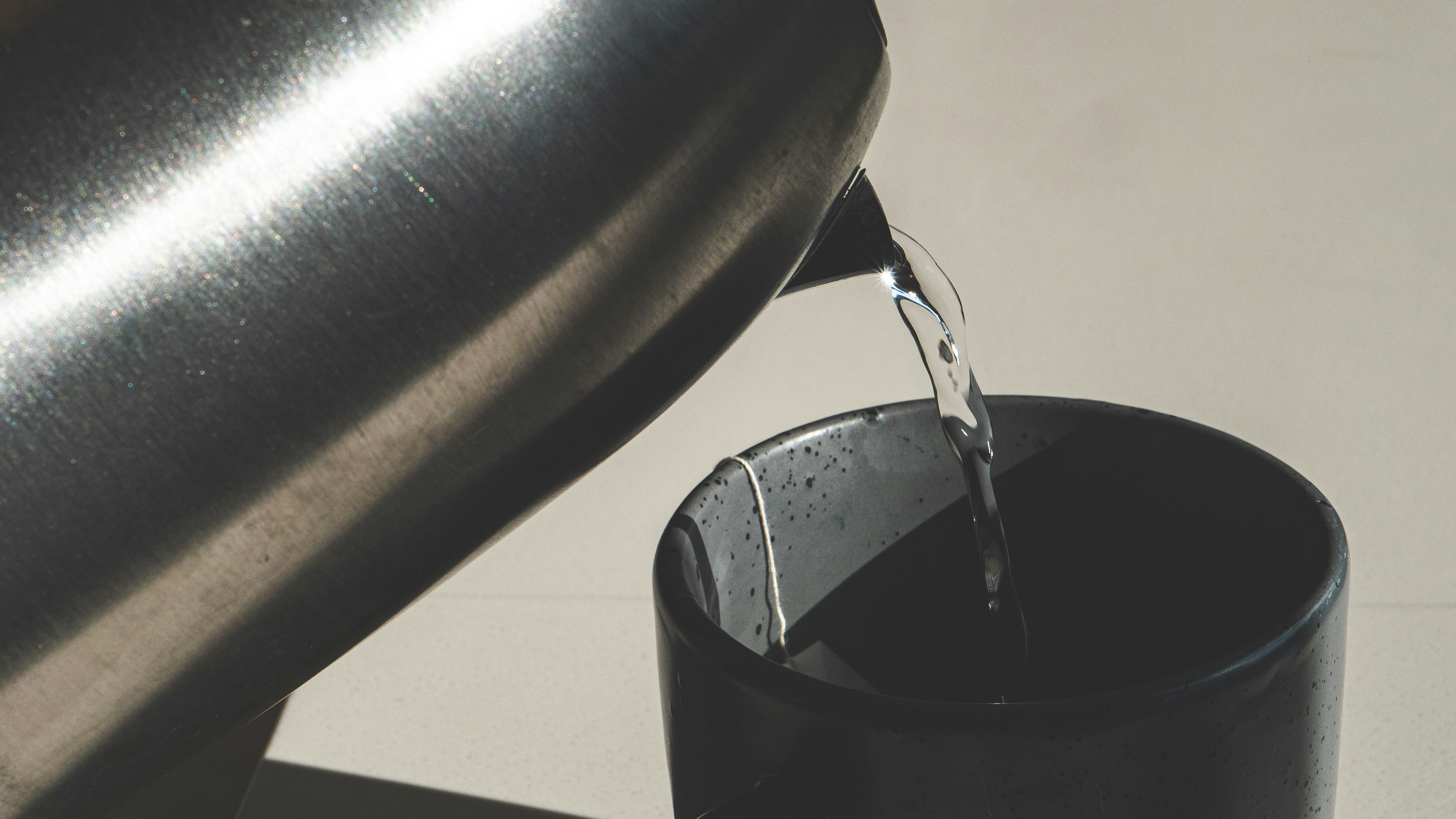 A black cup with water pouring out of it