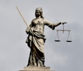 A statue of lady justice holding a sword and a scale