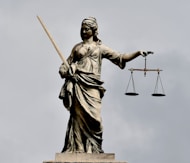 A statue of lady justice holding a sword and a scale