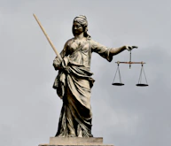 A statue of lady justice holding a sword and a scale