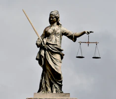 A statue of lady justice holding a sword and a scale