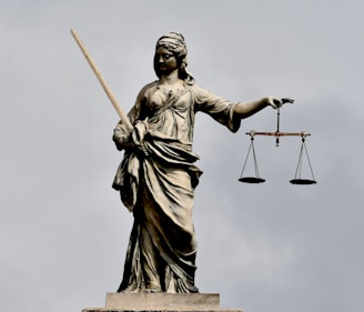 A statue of lady justice holding a sword and a scale