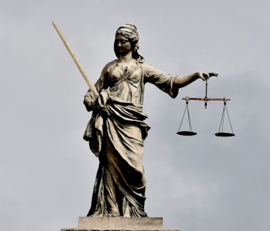 A statue of lady justice holding a sword and a scale