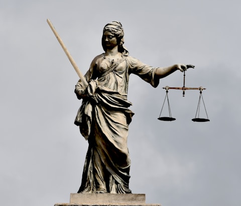 A statue of lady justice holding a sword and a scale