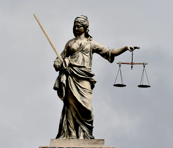 A statue of lady justice holding a sword and a scale