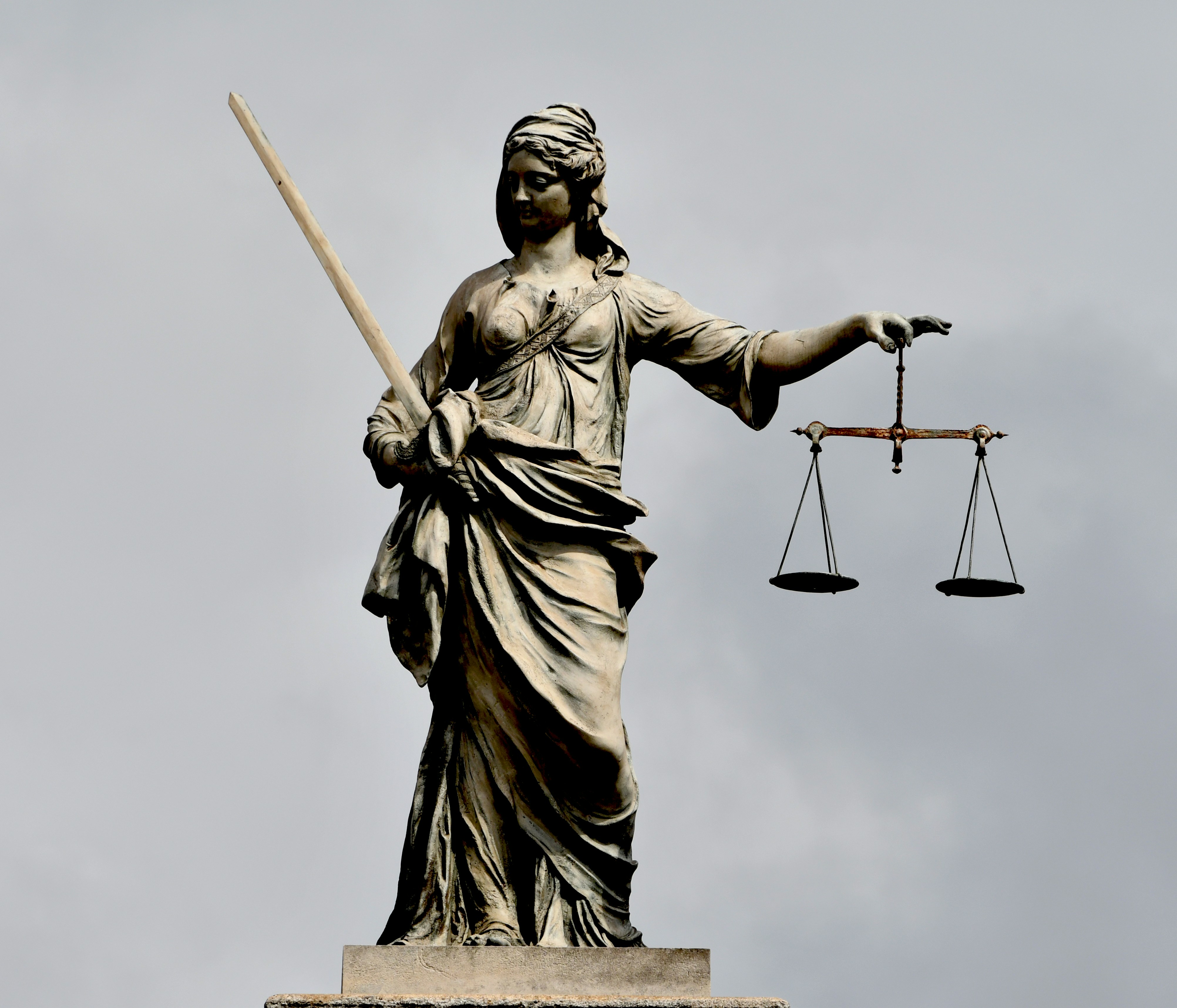 A statue of lady justice holding a sword and a scale