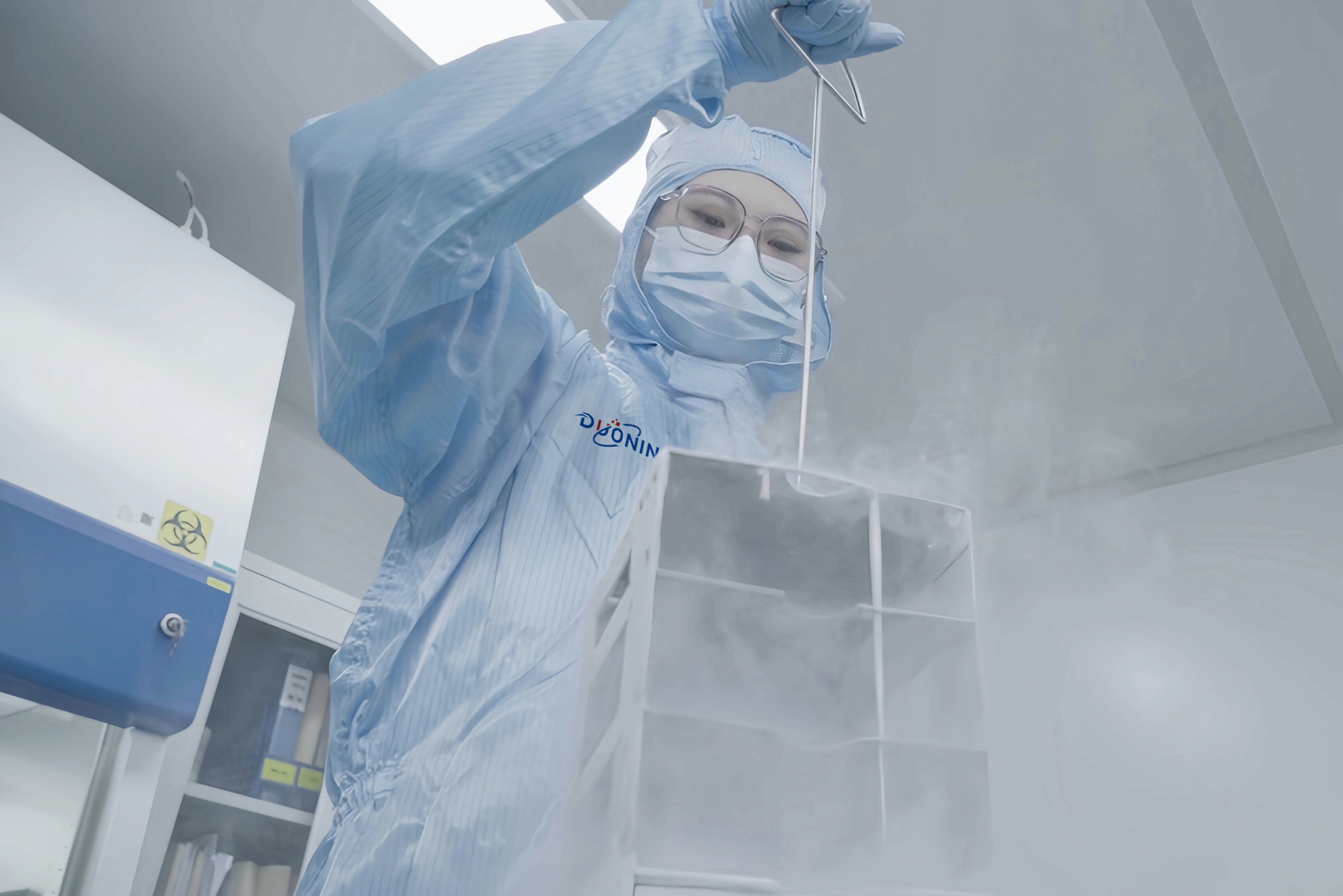 A person in a white lab coat and mask