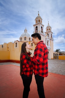 A man and a woman standing in front of a church
