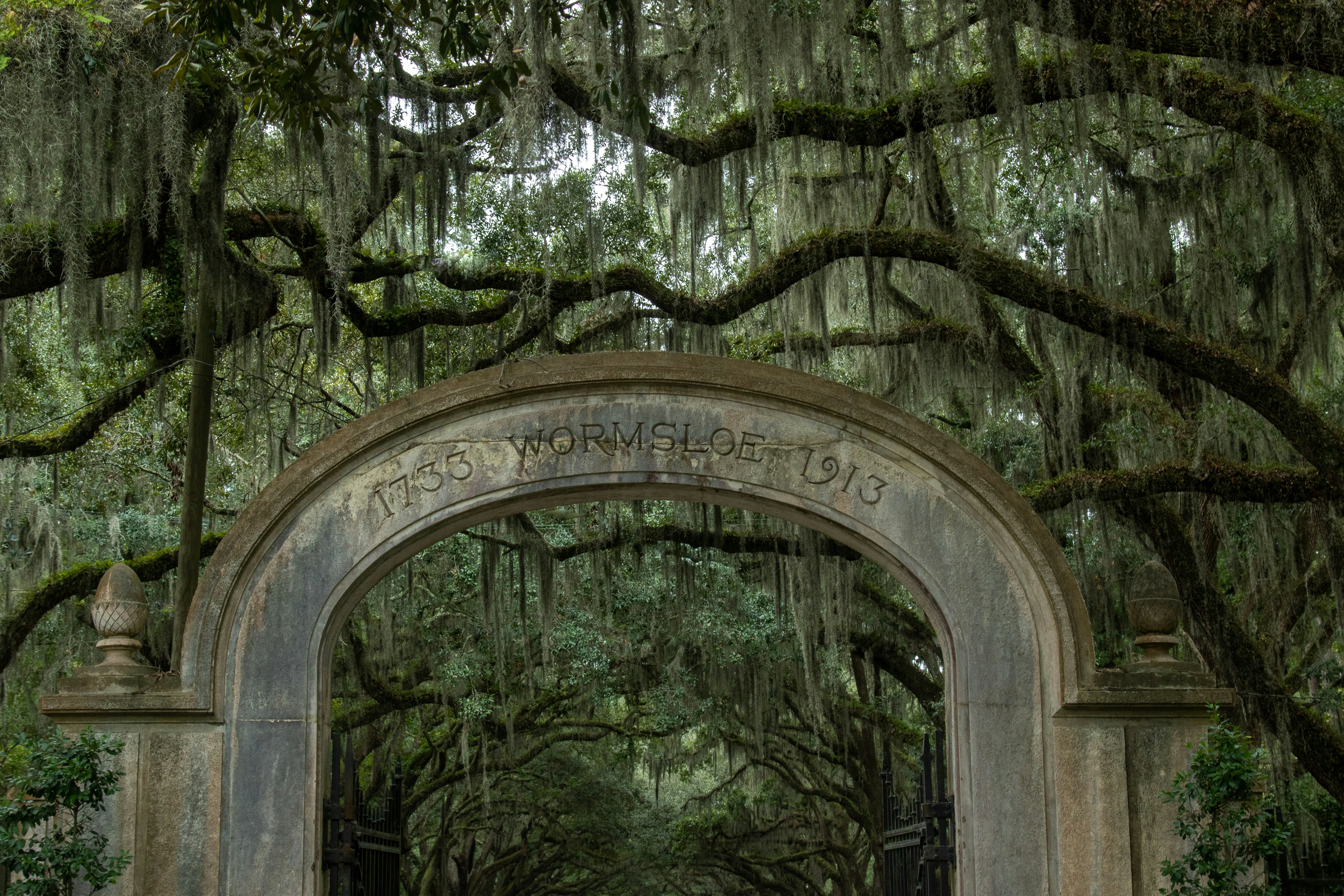 A large stone arch with trees in the background