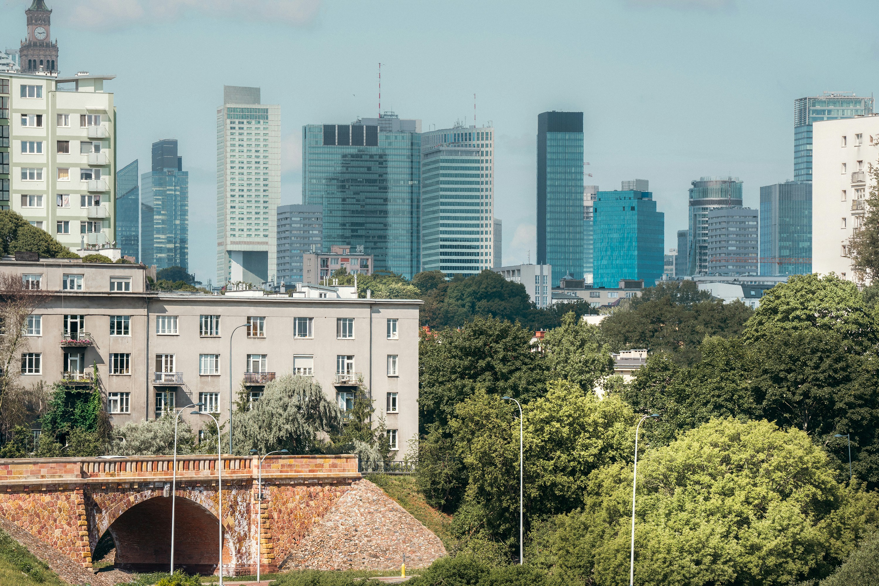 A view of a city with a bridge in the foreground