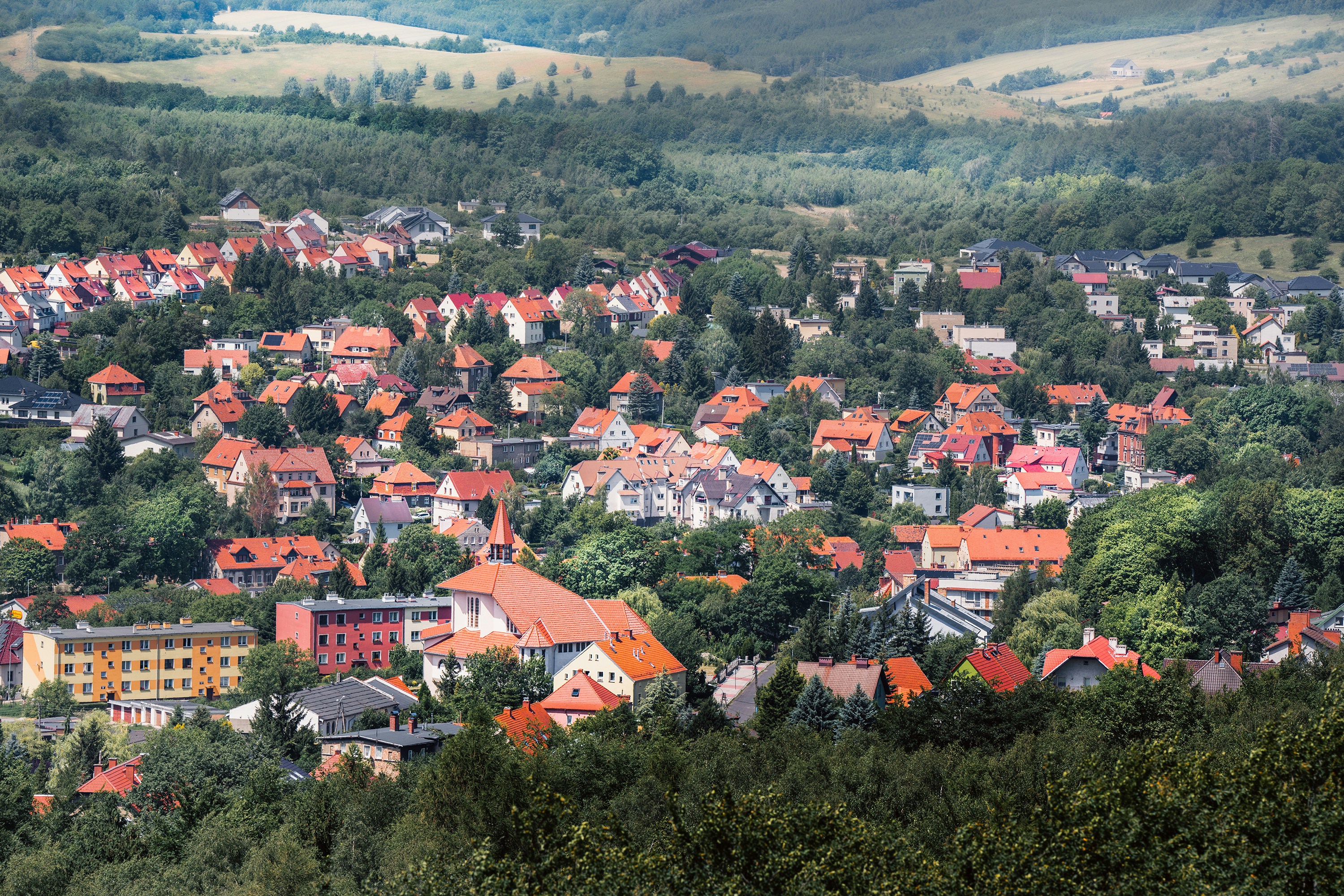 A small town surrounded by trees and hills