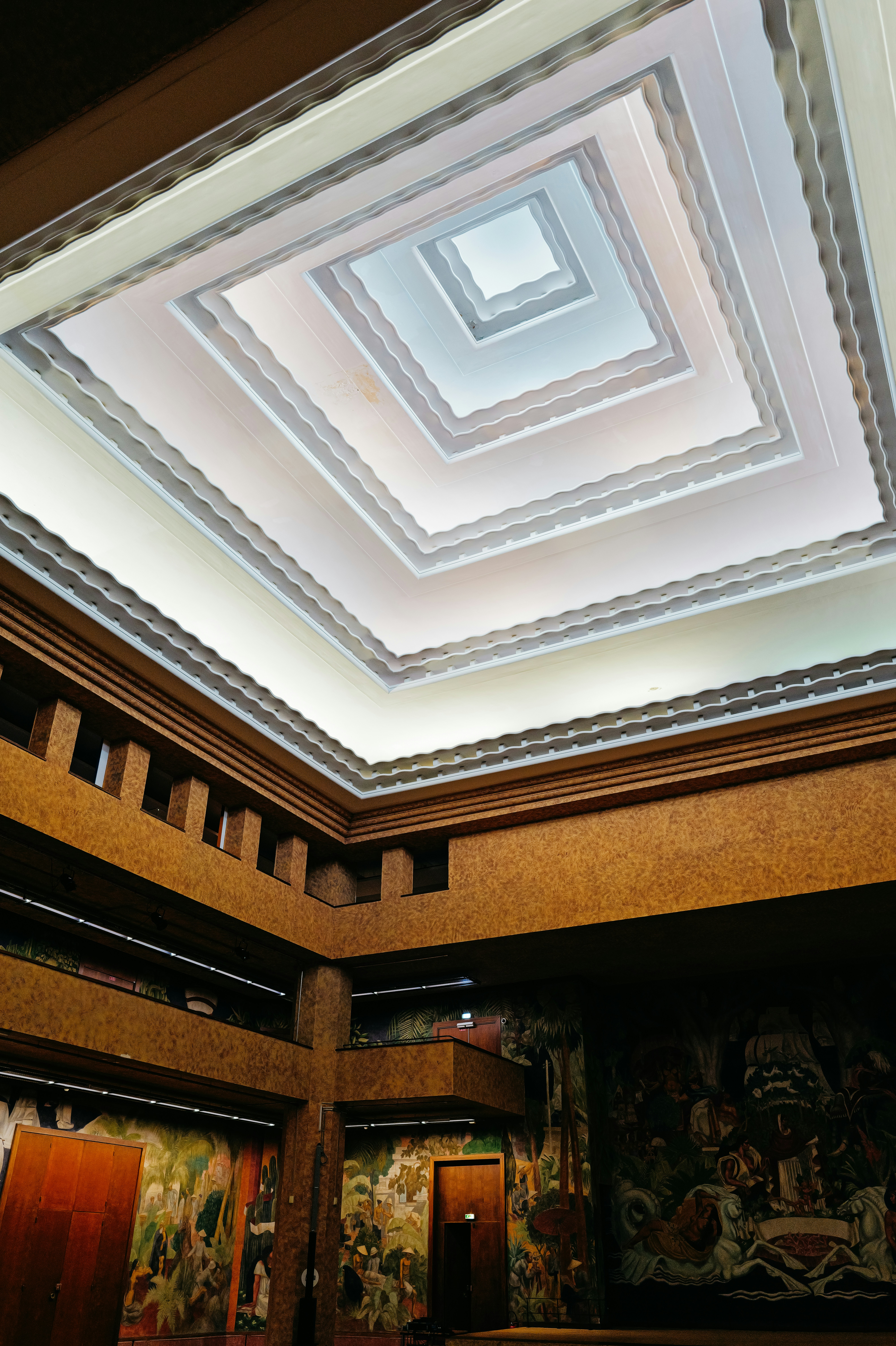 A room with a ceiling that has a painting on it