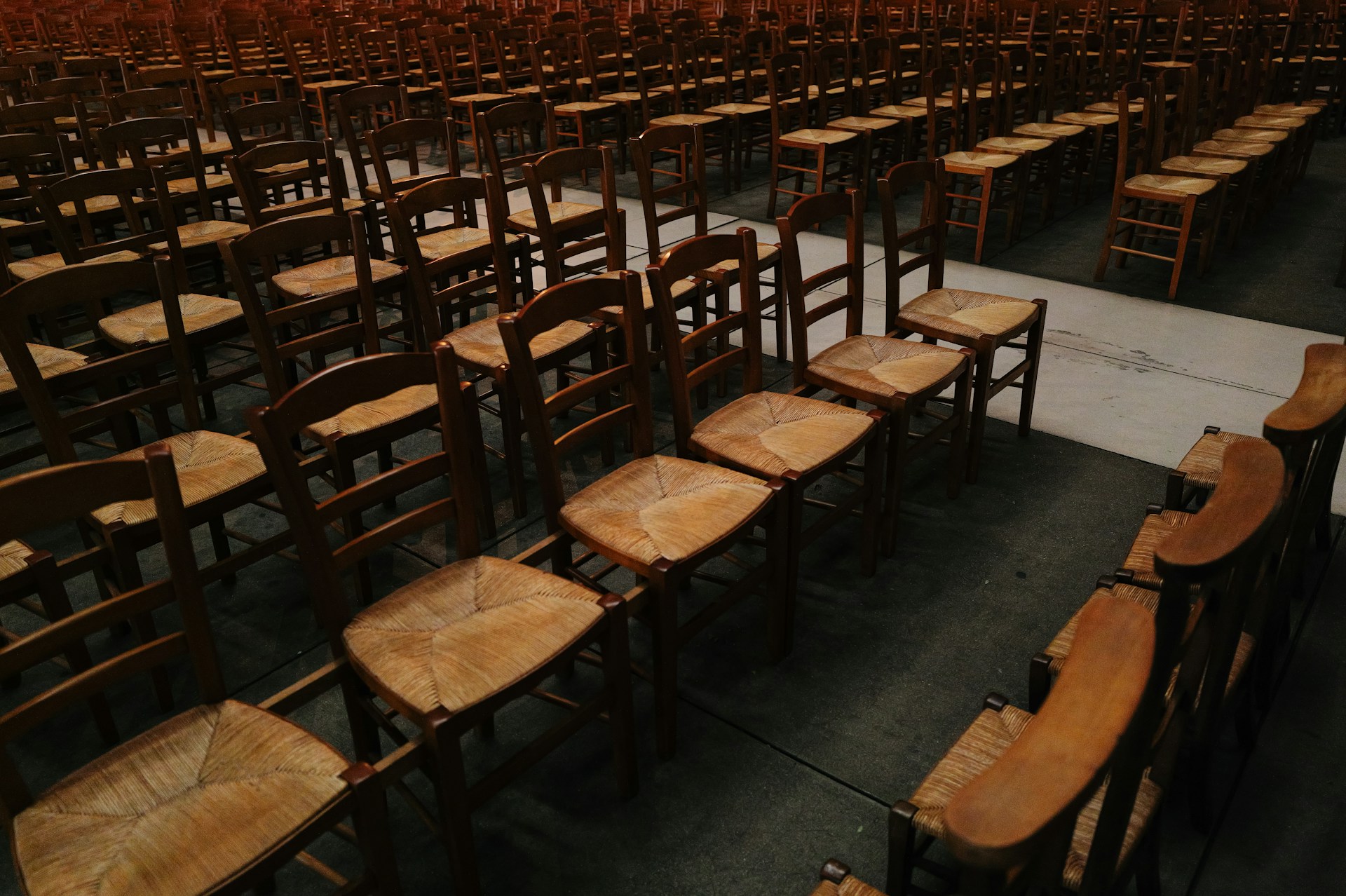 A room filled with lots of wooden chairs