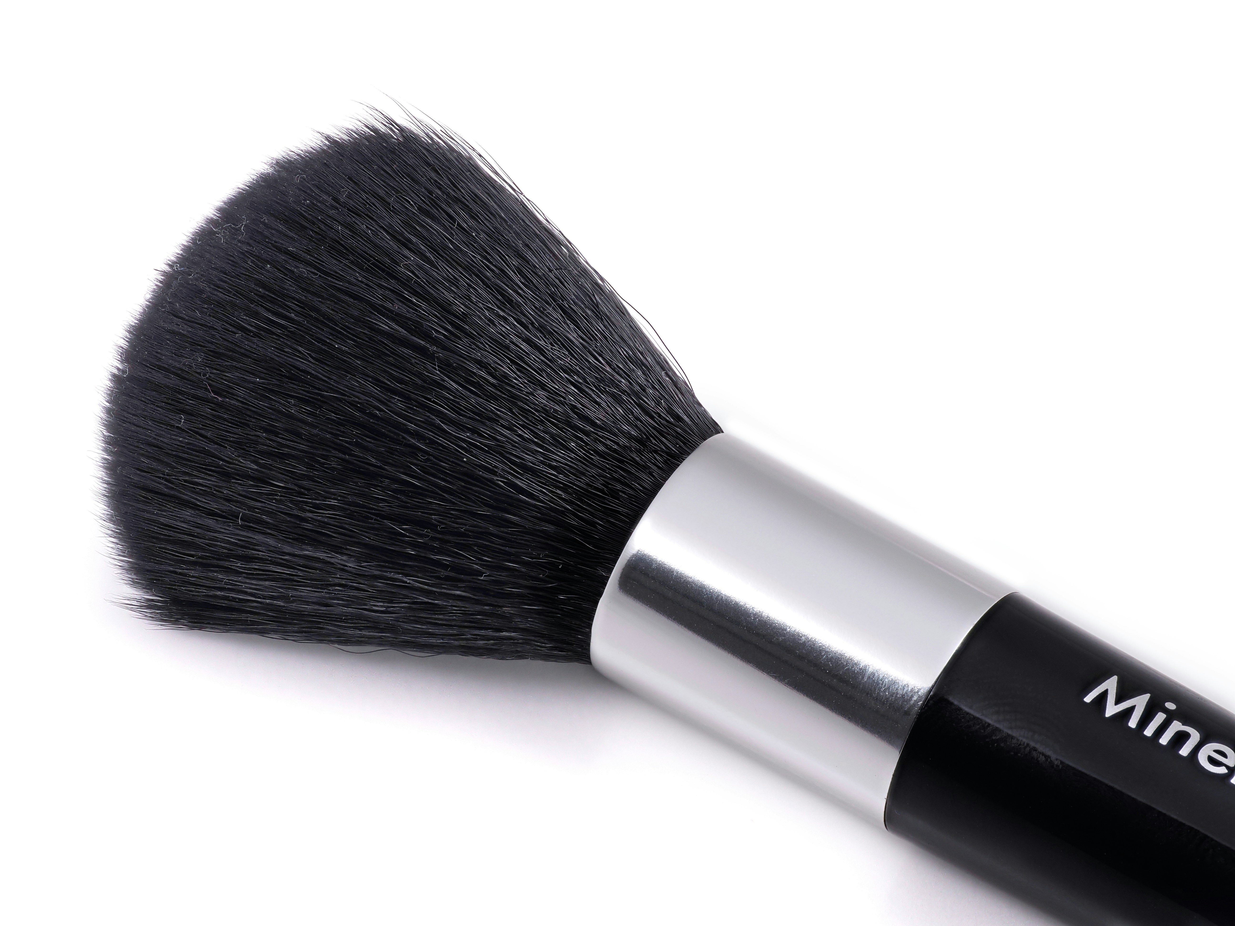 A close up of a brush on a white surface