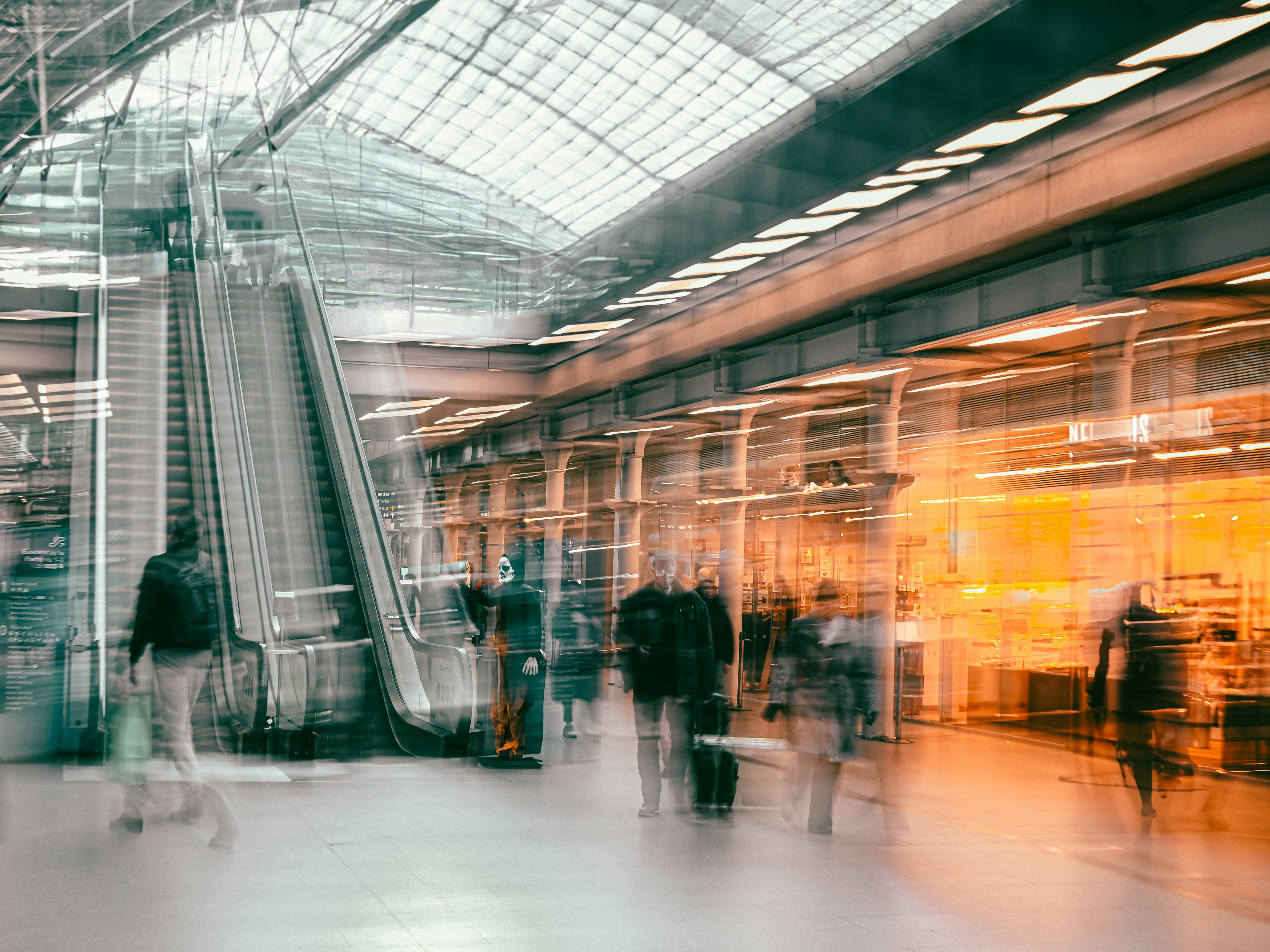 A blurry photo of people in a train station