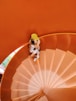 A doll sitting on top of a spiral staircase