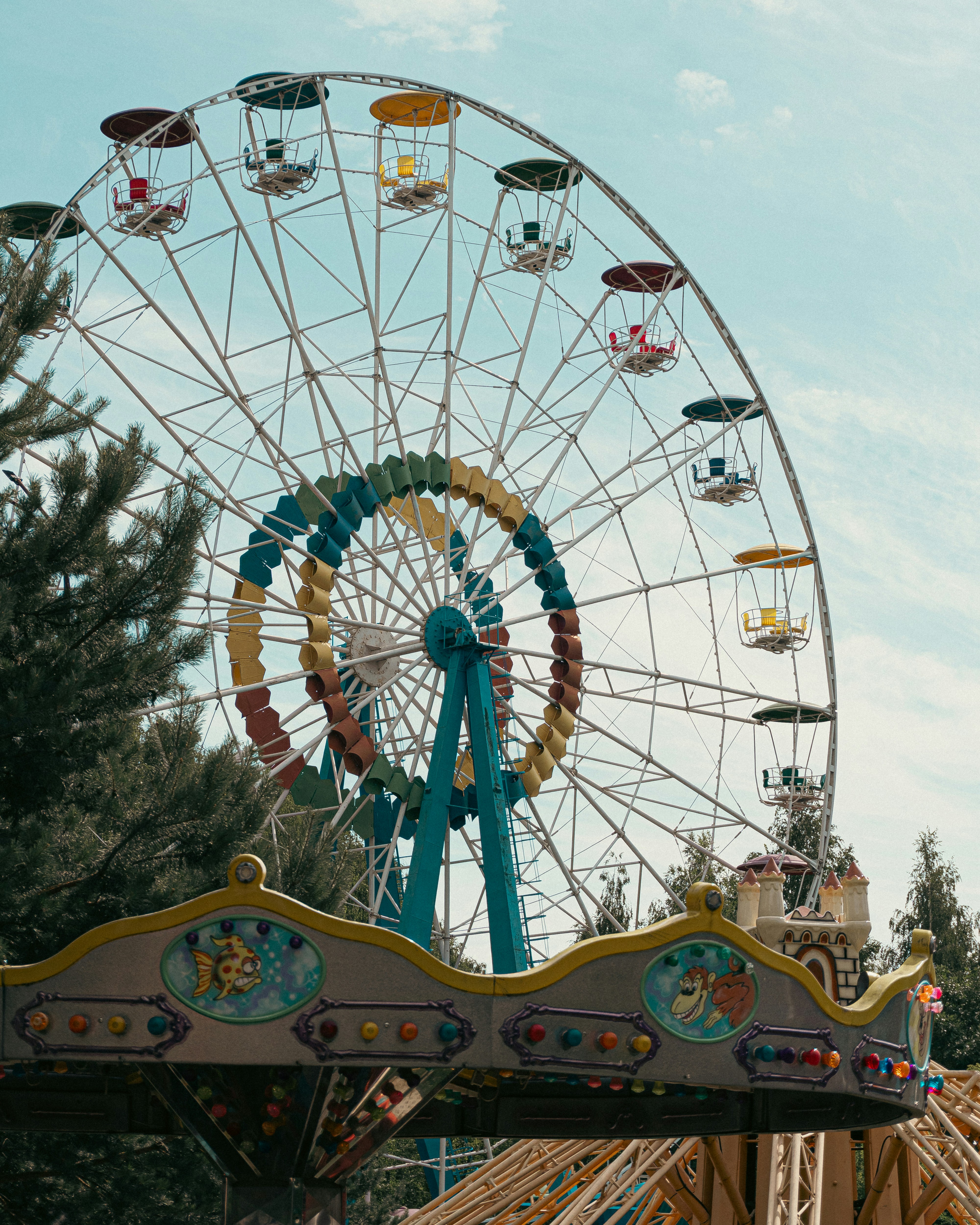 A carnival ride with a ferris wheel in the background
