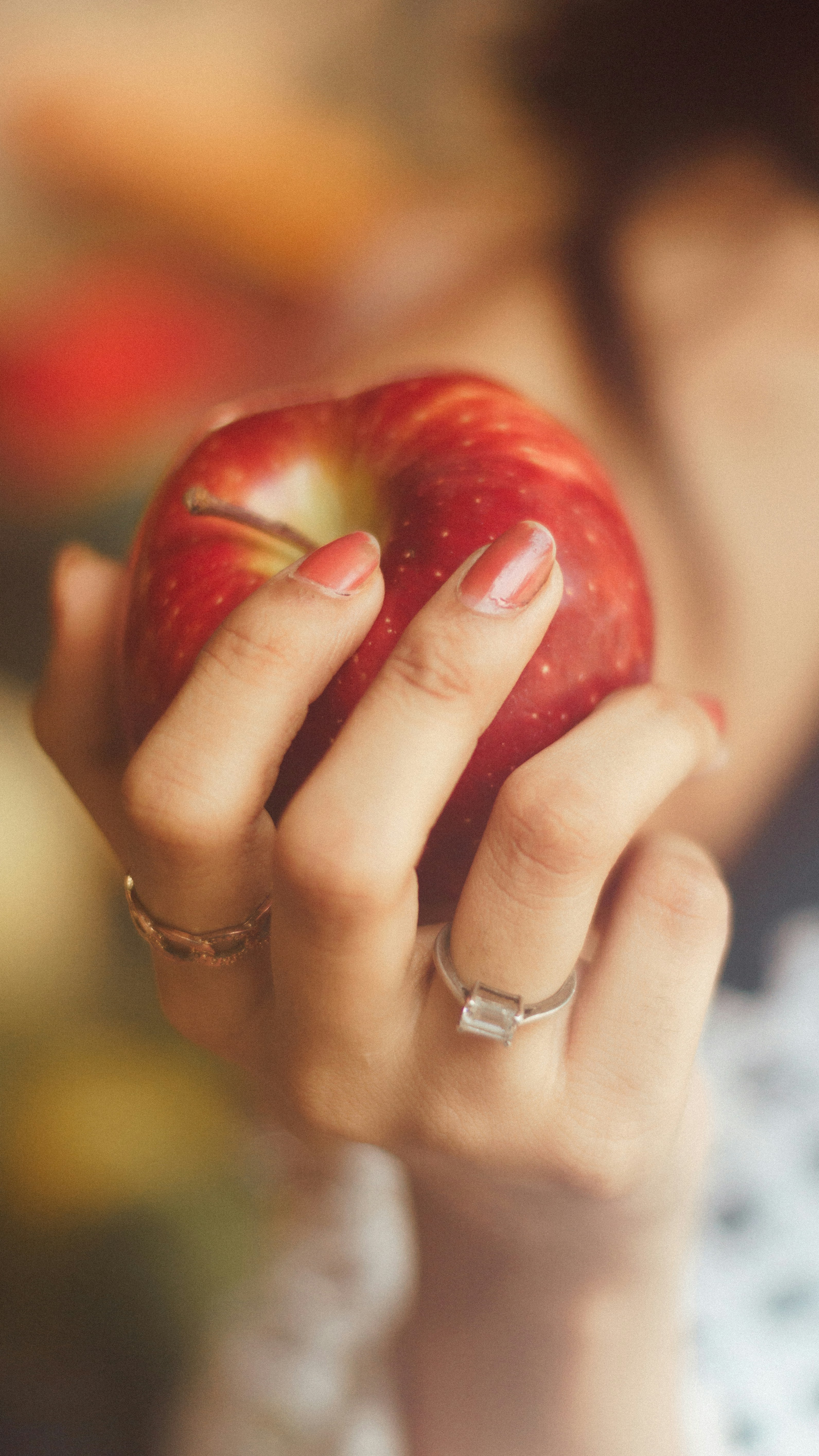 A woman holding an apple in her hand
