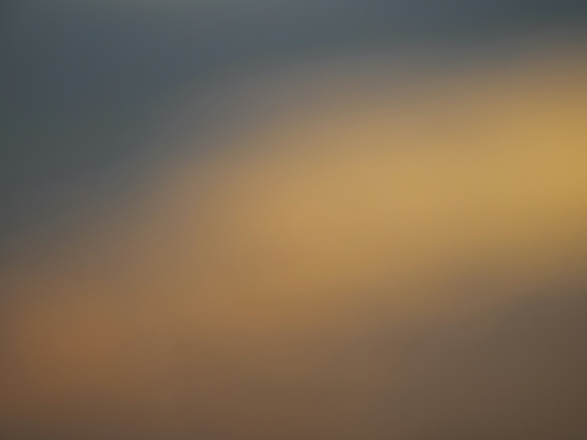 A blurry photo of a plane flying in the sky