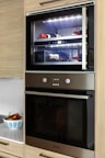 A kitchen with a built in oven and microwave